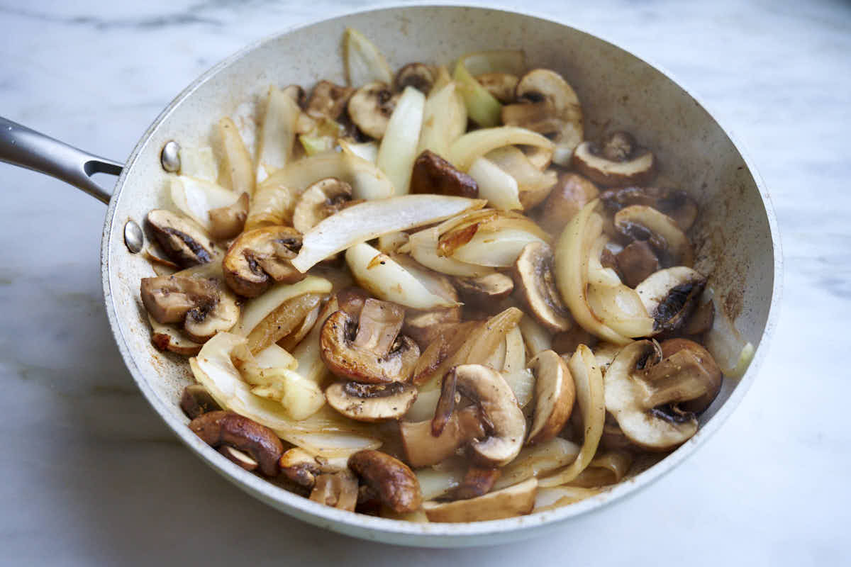 Roasted Mushrooms and Onions in a pan.