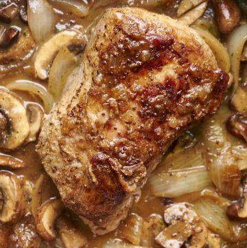 Stove Top Pork Loin in White Wine Sauce with Onions and Mushrooms in a pan