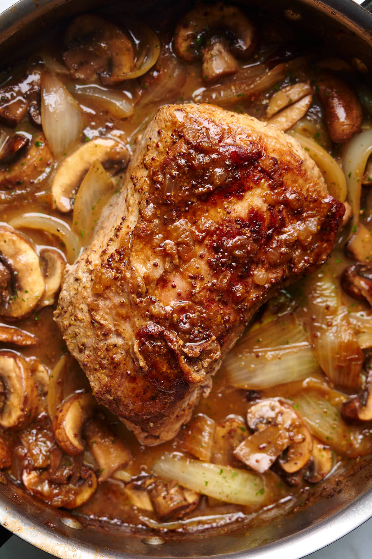 Stove Top Pork Loin in White Wine Sauce with Onions and Mushrooms in a pan